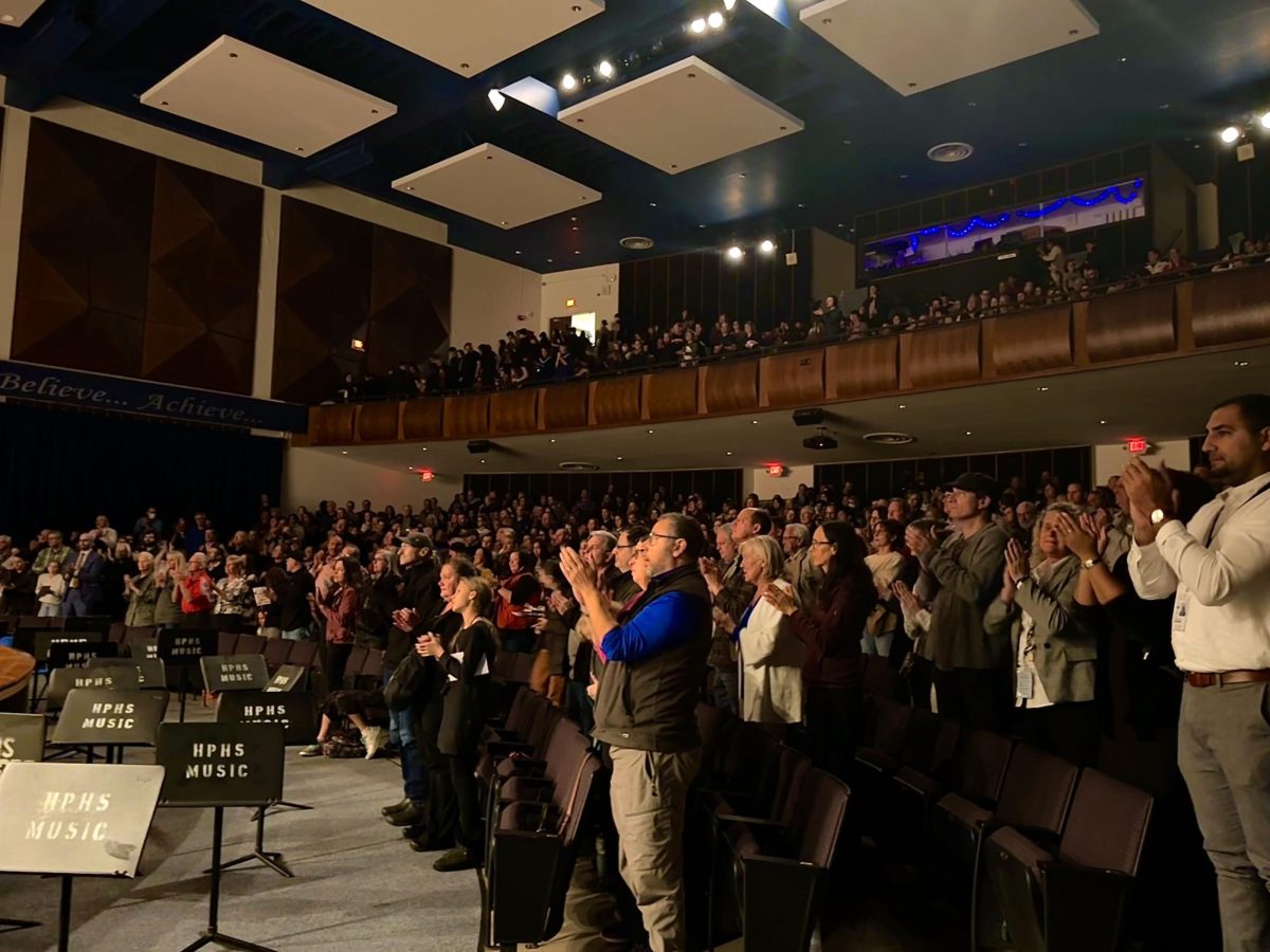 The audience gives a standing ovation to the Wind Symphony, showing their appreciation to everyone involved with making the world premiere happen.