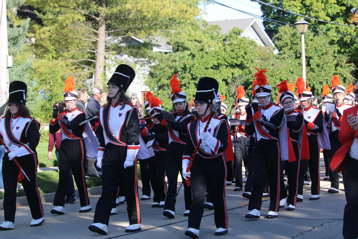 Following Dr. K, the LHS marching band walks behind, blaring the school’s fight song from their instruments. The marching band also performs at LHS football games on the sidelines including a half time performance on the field.