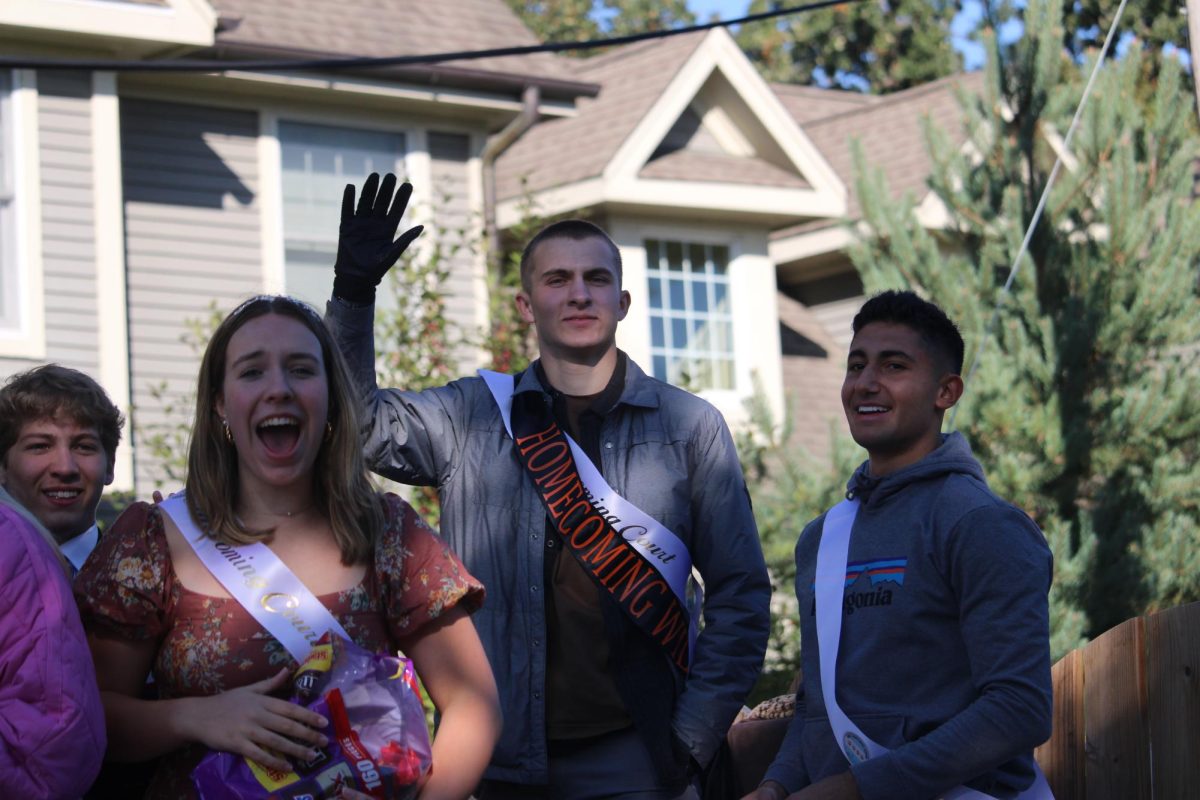 The 2023 Homecoming Wildcat, senior Henry Calsin, waves to onlookers and celebrates his outstanding accomplishment. Calsin is an active member of the LHS community, including being a member of Wildcat Productions and the varsity boys basketball team.