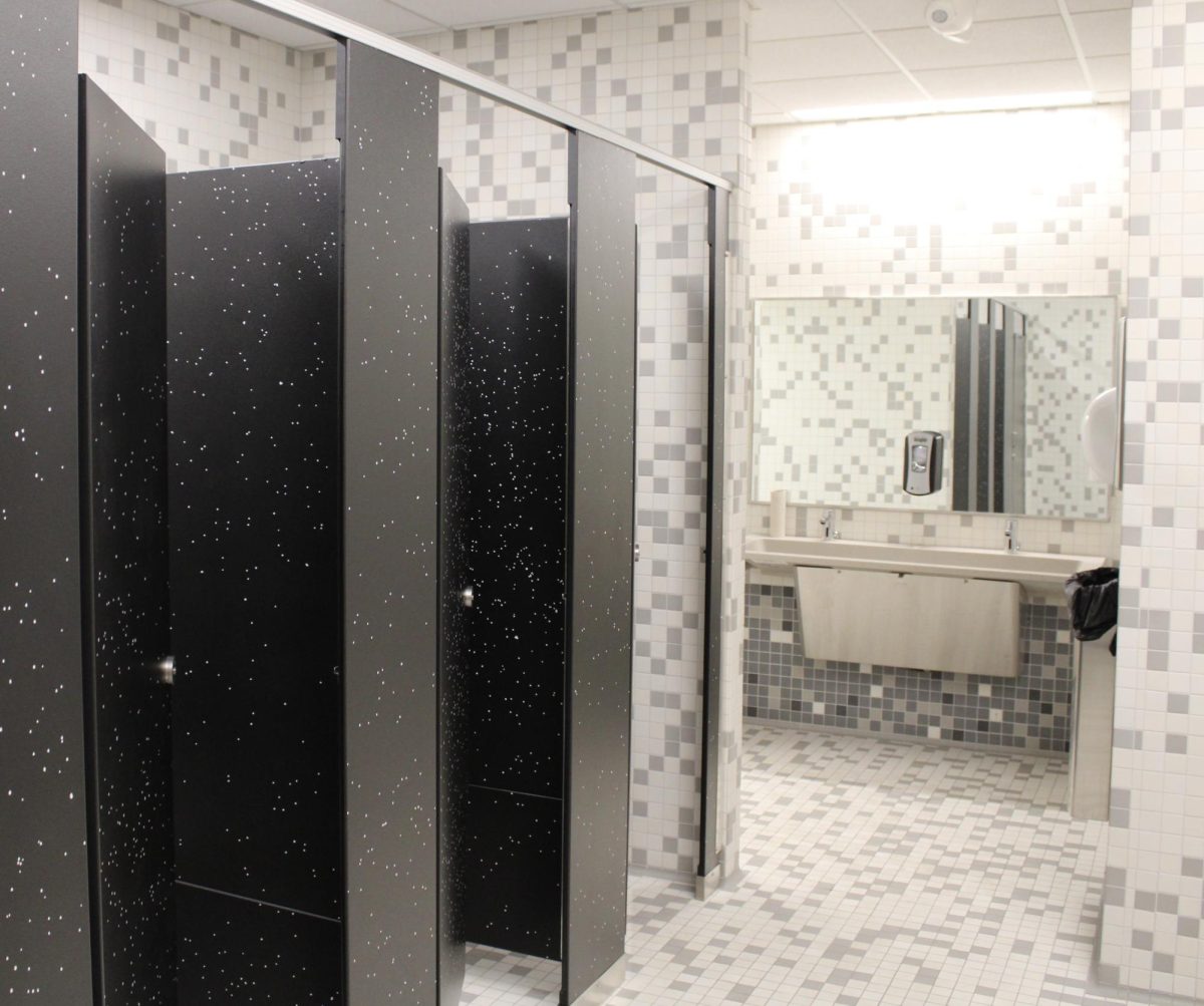 The gray and white tiles compliment the updated, 2019 pool locker rooms. The boys (upstairs) and girls (downstairs) bathrooms are located at the west ends of the main hallway.