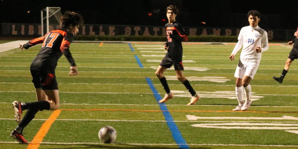 Junior Dominic McMillion (17) finds a gap to send the ball into the box, creating as many chances as possible to secure the win towards the end of the second half.