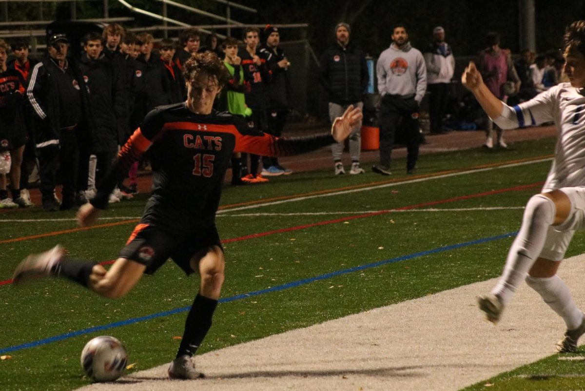 Senior Oliver Allen (15) searches for an opportunity to secure a goal for his team to tie the game. Despite facing a one-goal deficit to the Vernon Hills Cougars, Allen’s effort on the field paid off with a goal off a cross from senior Mateo Portillo (10) later in the game.