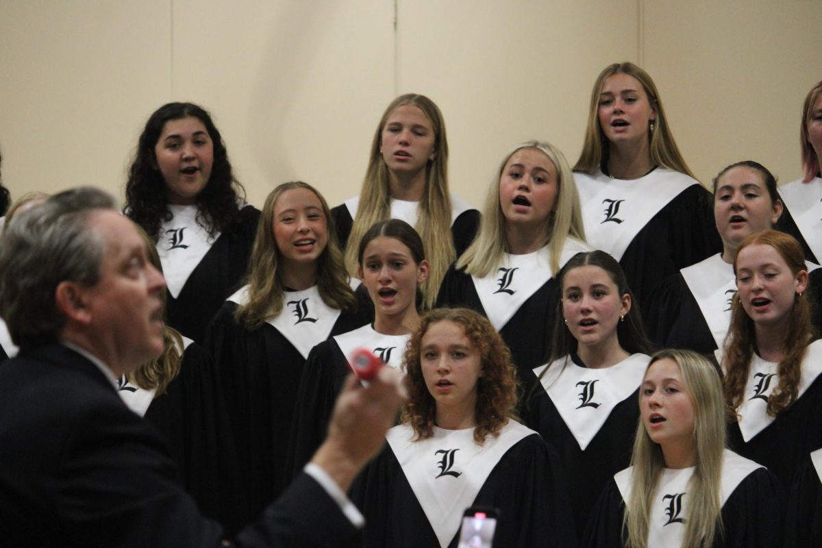 Dr. Jeffrey Brown, choir director and teacher for all the choir groups, conducts his choir students in one of the night’s many pieces.