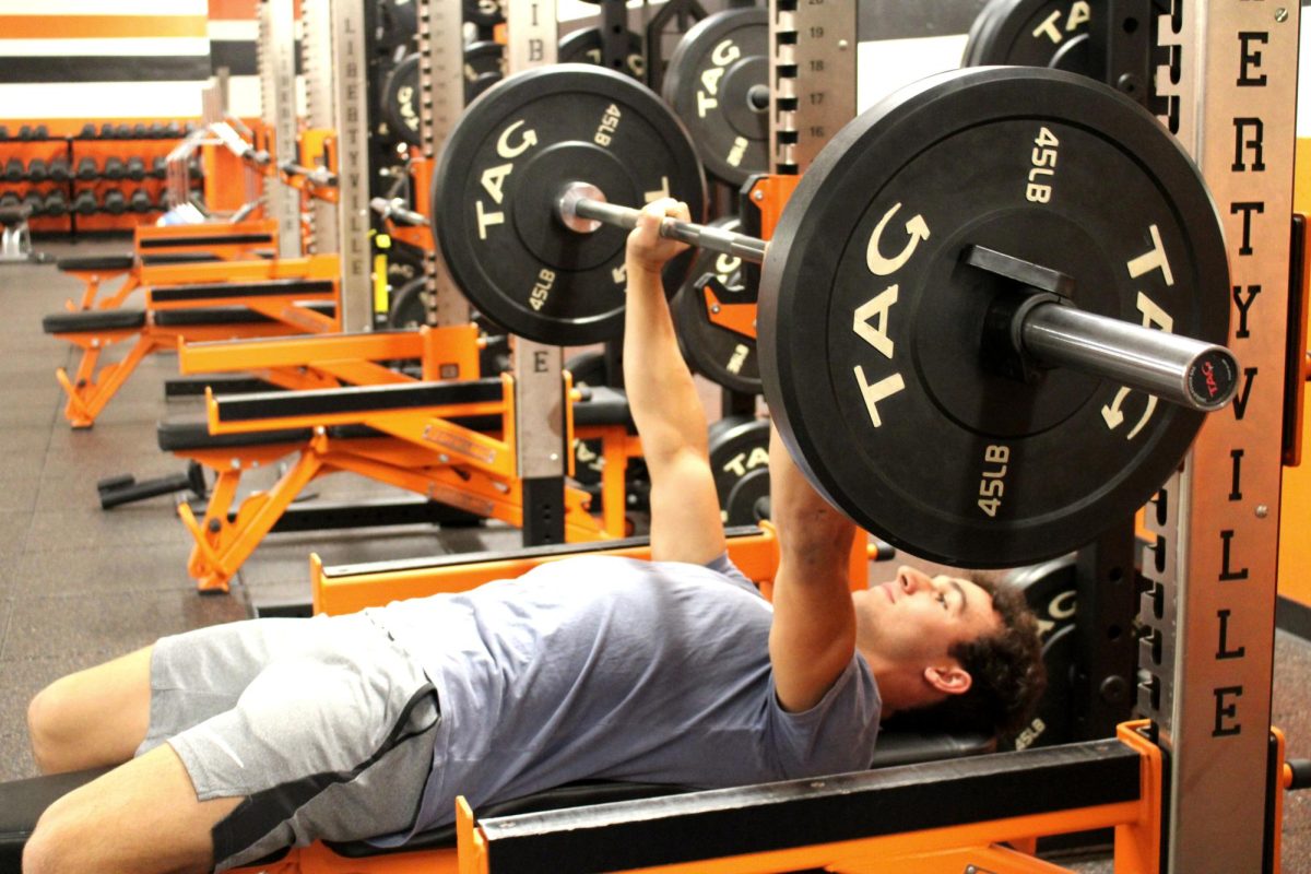 In the spirit of pushing the rock, senior Charlie Clark lifts weights to train for his role as a middle linebacker and running back on the varsity football team, a feat that takes hard work and no shortcuts. Clark (34) and other members of the team spend a lot of time in the weight room preparing for upcoming games.