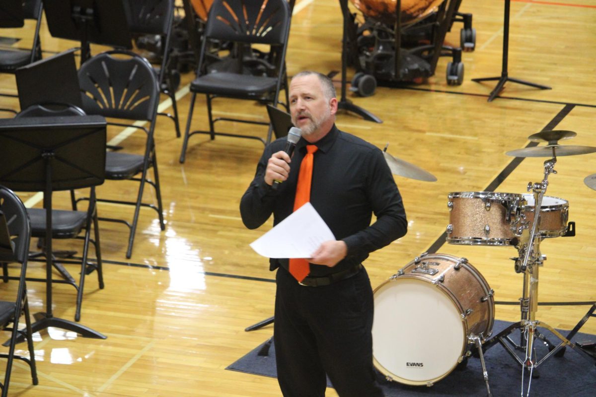 Mr. Adam Gohr, director of all LHS bands, introduces the pieces to be played and the band members. Gohr chose specific pieces with various meanings and backgrounds for the band festival. “It’s a little bit of everything,” Mr. Gohr said. “The one tune we are doing for the mass-band focuses on mental health and that’s something that’s very important to all of us. We also have [“Seminole Snake Dance”], one of the first pieces we’ve done by a Native American composer and it’s Native American Heritage Month.”