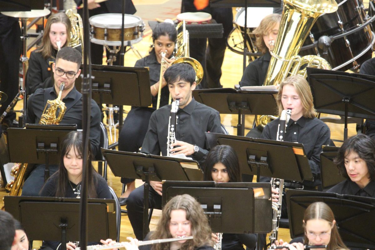 Senior Razi Mohammed, plays his Bass Clarinet in the Wind Ensemble. Like many seniors,  he began his music career during the height of the pandemic. “You know people were in masks, people wore covers on the instruments and you know now youre really starting to see people shine after being dormant for all these COVID years,” senior Mohammed, also a member of the Jazz Ensemble, said.