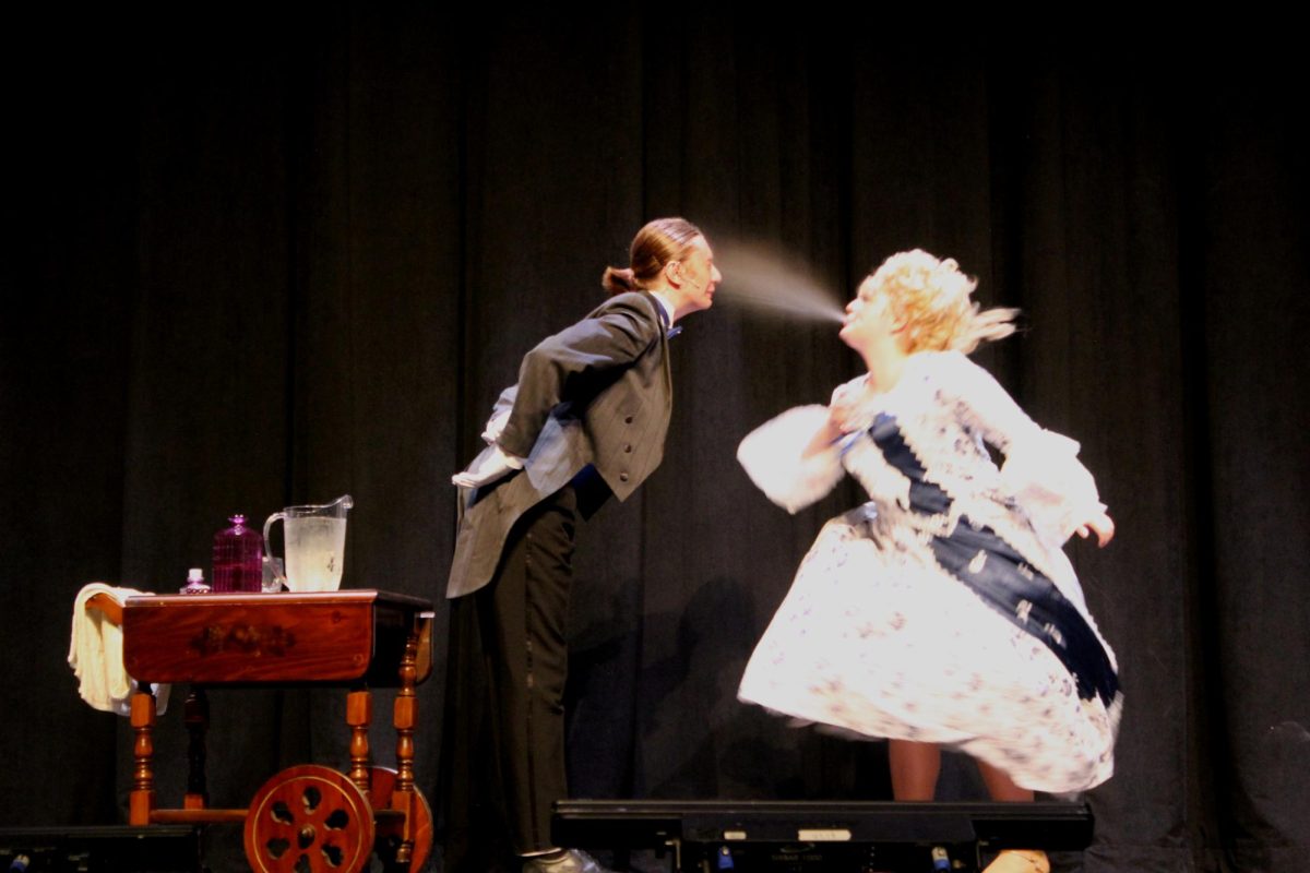 Junior Rosie Wagner performs one of many spit-takes which junior Jake Potter takes in his face over and over again. Wagner and Potter portrayed vaudeville actors Mrs. Tottendale, who wants ice water in this scene, and The Underling who serves vodka.