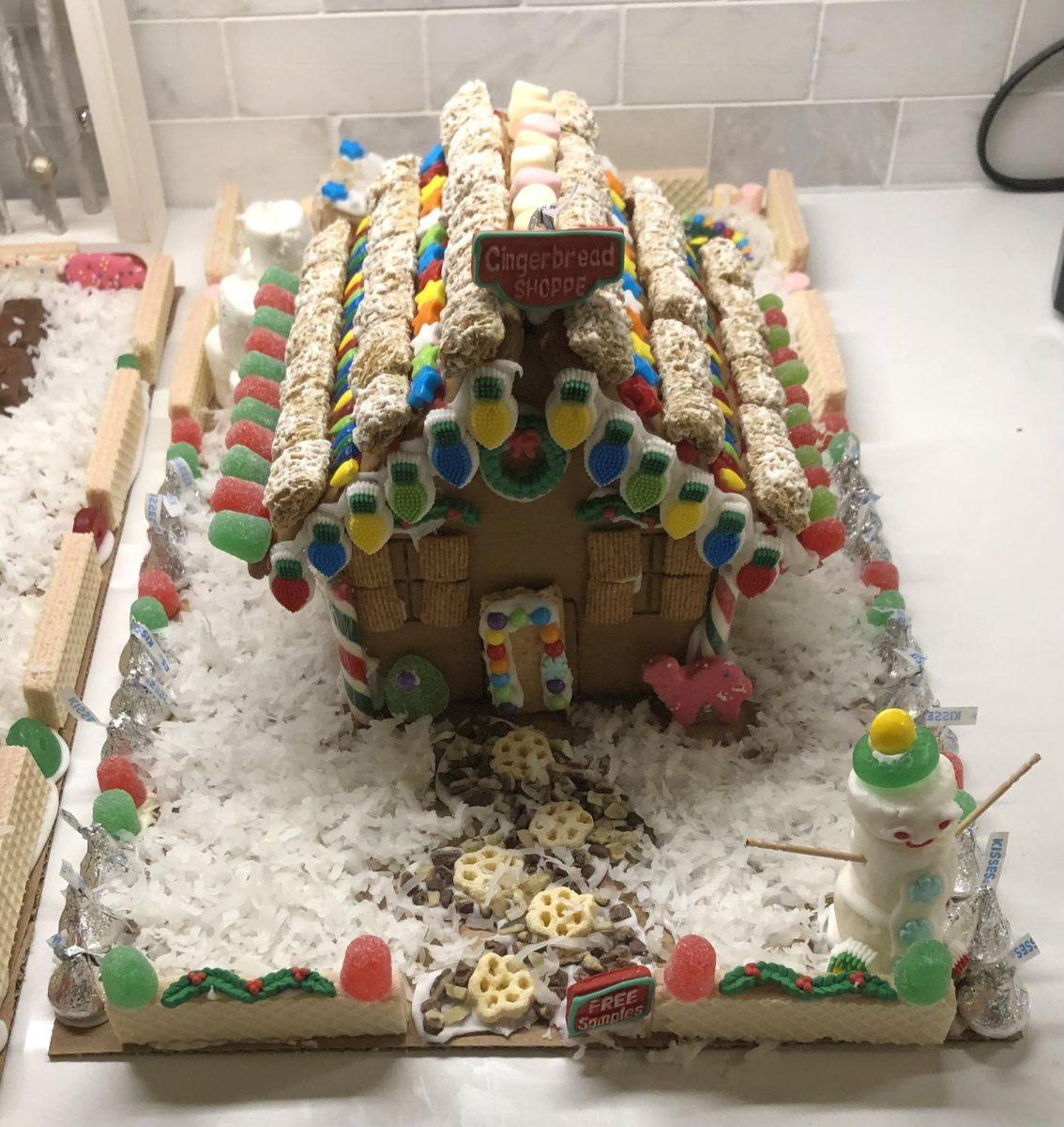 A cereal that works well for the roof of the house is Shredded Wheat, perfect for a snowy effect. There are also windows made from Golden Grahams and a path made from honeycomb cookies. 