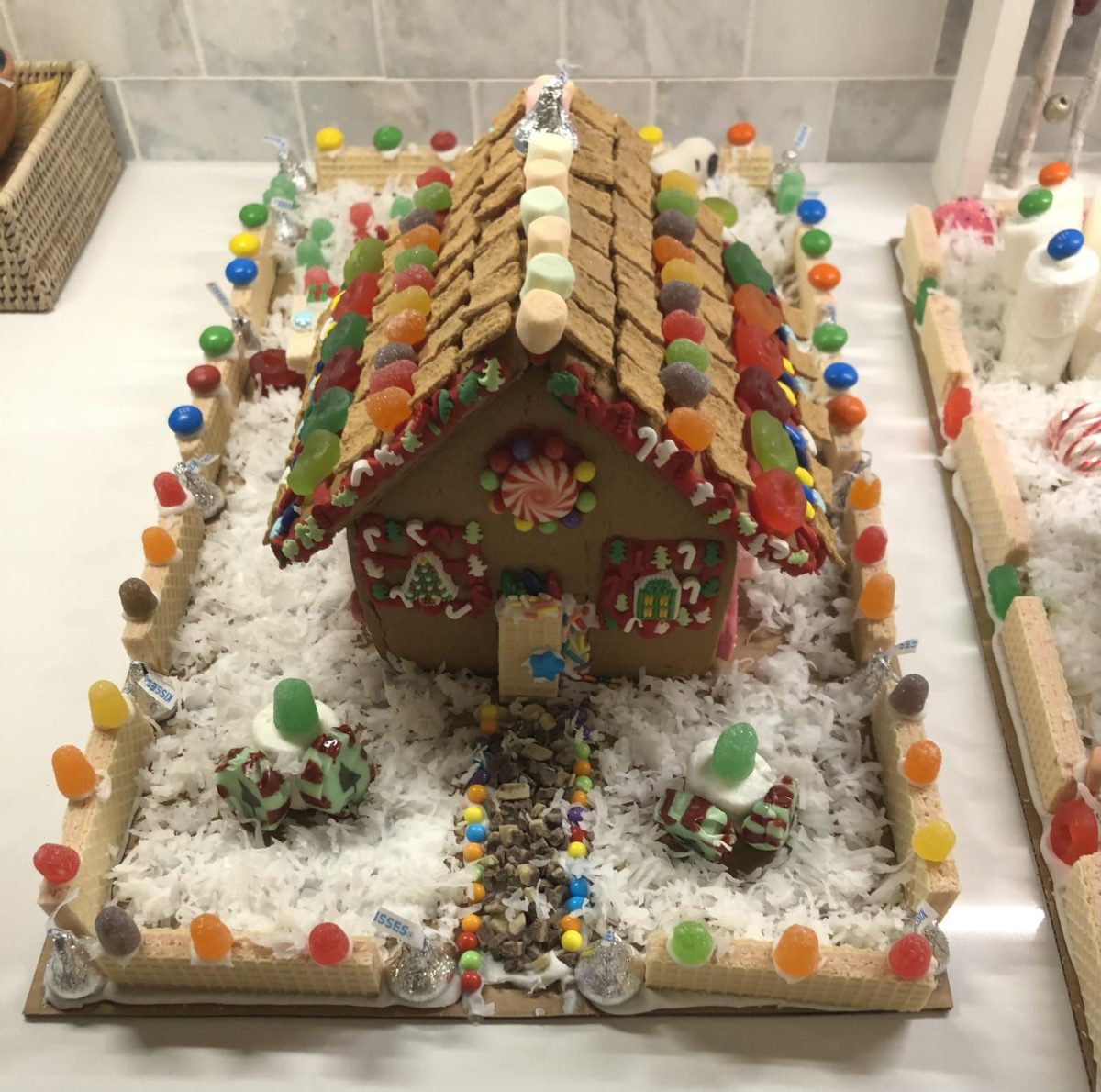 Another cereal that works well for gingerbread houses is Golden Grahams which are added to be a more traditional shingle-looking roof along with Lifesavers, gumdrops, marshmallows and a Hershey’s Kiss chimney.