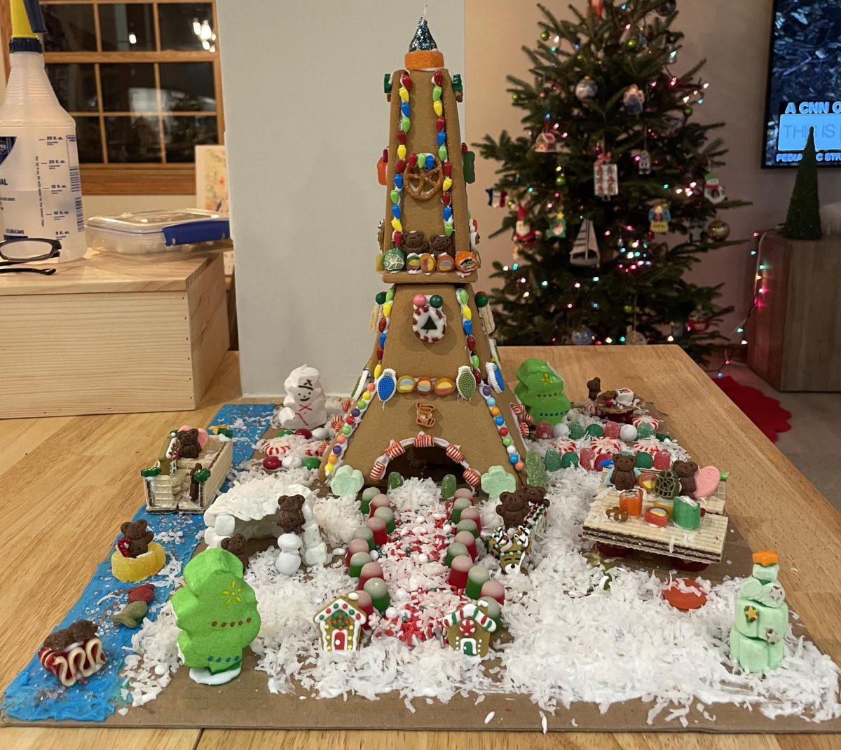 One of the most unique gingerbread houses that we’ve made is the Eiffel Tower gingerbread house that my sister, Grace, made in 2022. It isn’t a traditional gingerbread house, so the decoration for the house was different from what we’ve done in the past. She decorated with candies like chocolate Teddy Bears, sprinkles, hard candies, pretzels and a Hershey’s Kiss on top. She also created the Seine River using blue icing and sprinkles and created a wafer boat and a gummy raft.