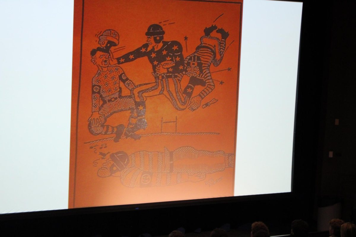The photo shows World War II propaganda found in the Nautilus. The football player is fighting and winning against the Axis Power leaders. During this time war Propaganda was so common that it seeped into public schools, with art like this being commonplace. 