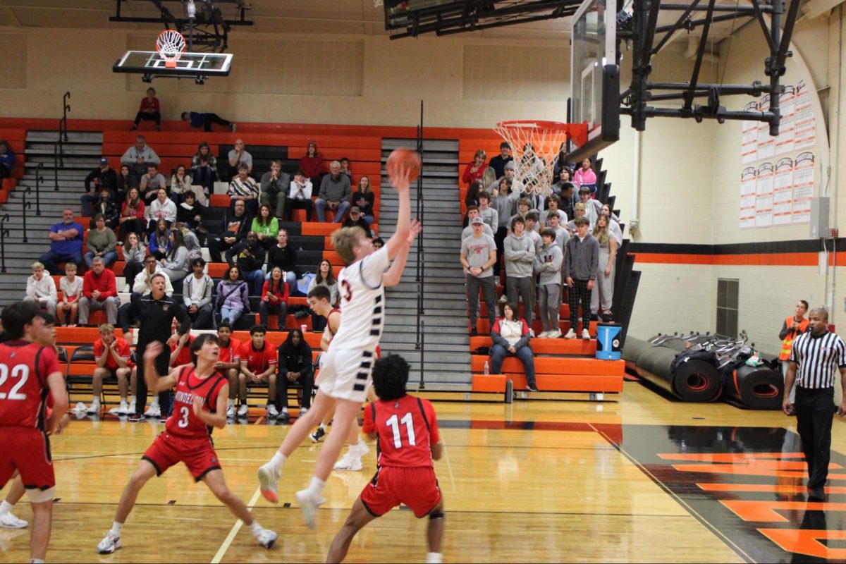 Senior Ben Van Lyssel (3) goes in for a layup. Van Lyssel made a total of seven layups throughout the game, ultimately recording a team high of 32 points.