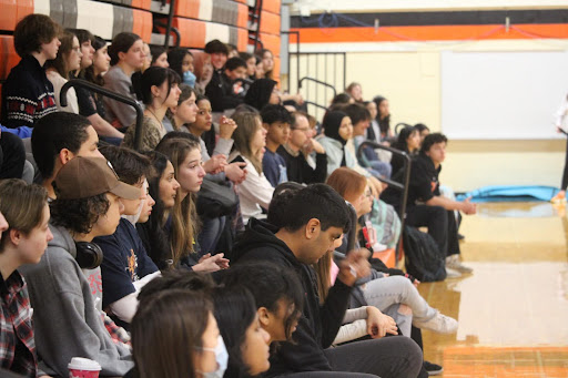 130 students and staff participate in a rally to promote peace between Israel and Palestine in the main gym bleachers before school. Many wore white ribbons that were passed out at the door to show their support for peace. 