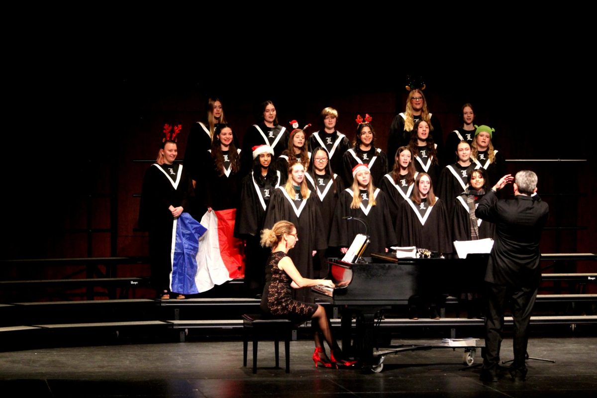 Bel Canto, the advanced choir consisting entirely of junior girls, sings “12 Or So Days of Christmas” by Paula Foley Tillen. In the song, Tillen refers to “three French hens,” so Bel Canto waves French flags at the end of the song, which also incorporates the opening notes of the French national anthem. 