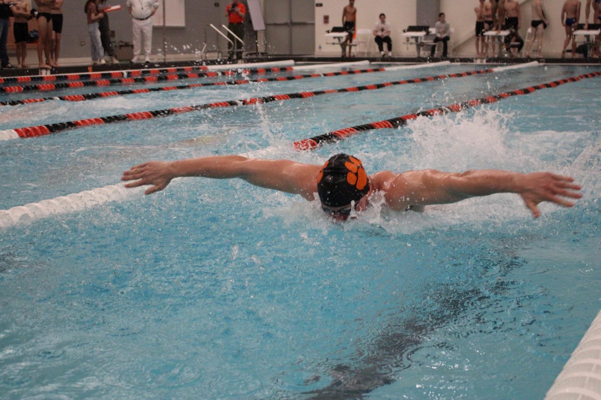Senior Sam Rasin tears through the water during the 200 yard medley relay. 
Rasin, who is the senior team captain and has been swimming since he was eight years old, shared that his strategy for the meet was to “get everybody hyped and everybody encouraging one another.”
