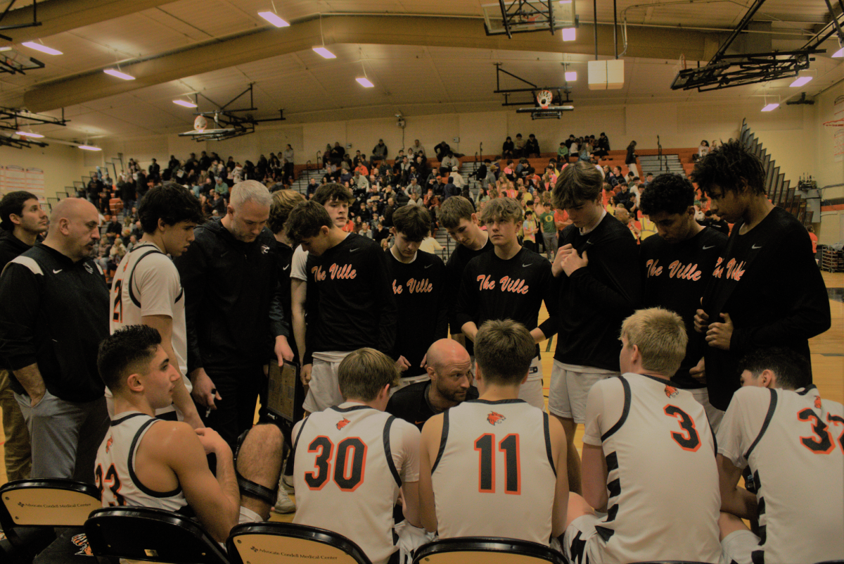 On Jan. 19, 2024, the varsity boys basketball team huddles together during a tough game against the Warren Township Blue Devils. This close game, which the Blue Devils narrowly won 77-69, was a result of the hard work and communication between this team. Senior Henry Calsin said that “whether [we’re] up or down in the game, we've gotten a lot better at knowing how to [communicate] in a good and competitive manner.” 