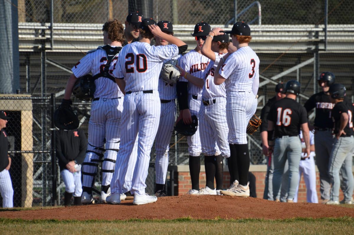 The team comes together at the pitcher’s mound during their Monday, March 11 victory over the Crystal Lake Central Tigers.Their next game is away against the Barrington Broncos on Wednesday, March 13. 