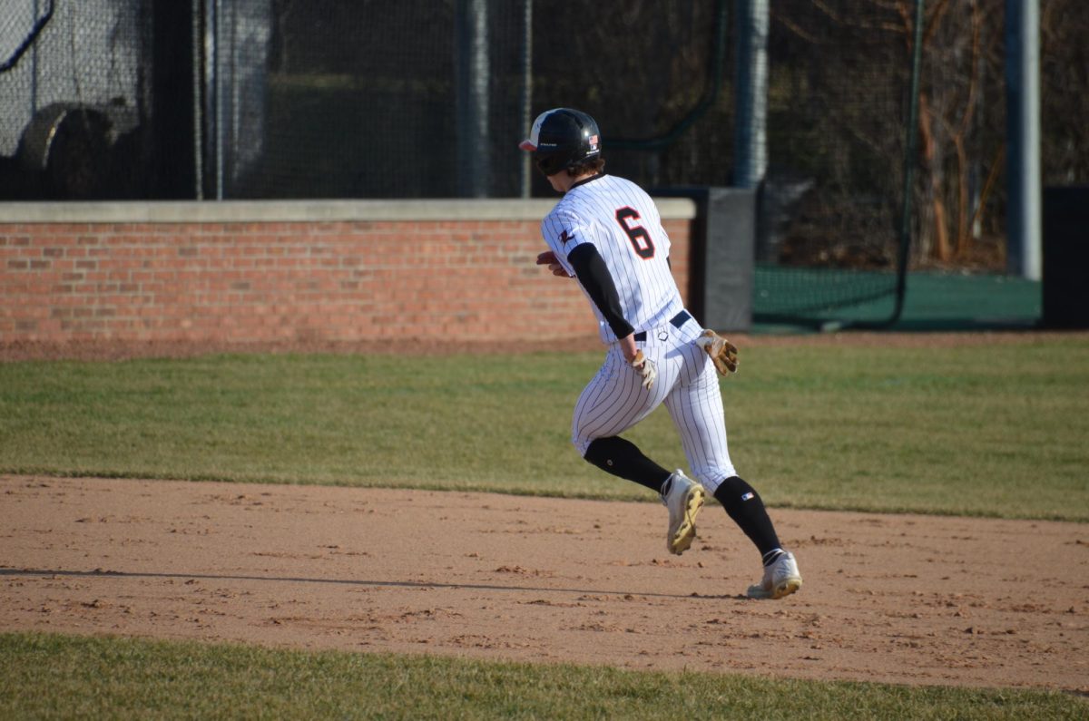 Junior Johnny Leoris (6) heads to third base. Leoris helped the team’s early 2-0 lead in the first inning with his hit to the outfield.