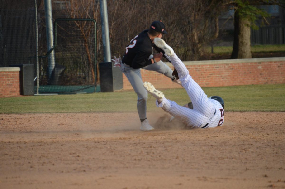 Junior Zach Seiler (20) slides onto second base.
