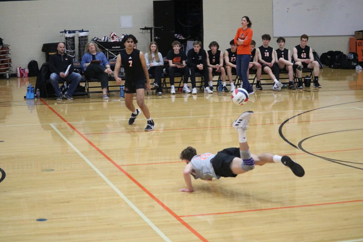 Sophomore libero and outside hitter Jackson Kern (11) dives for the ball. Kern had seven digs across both sets.
