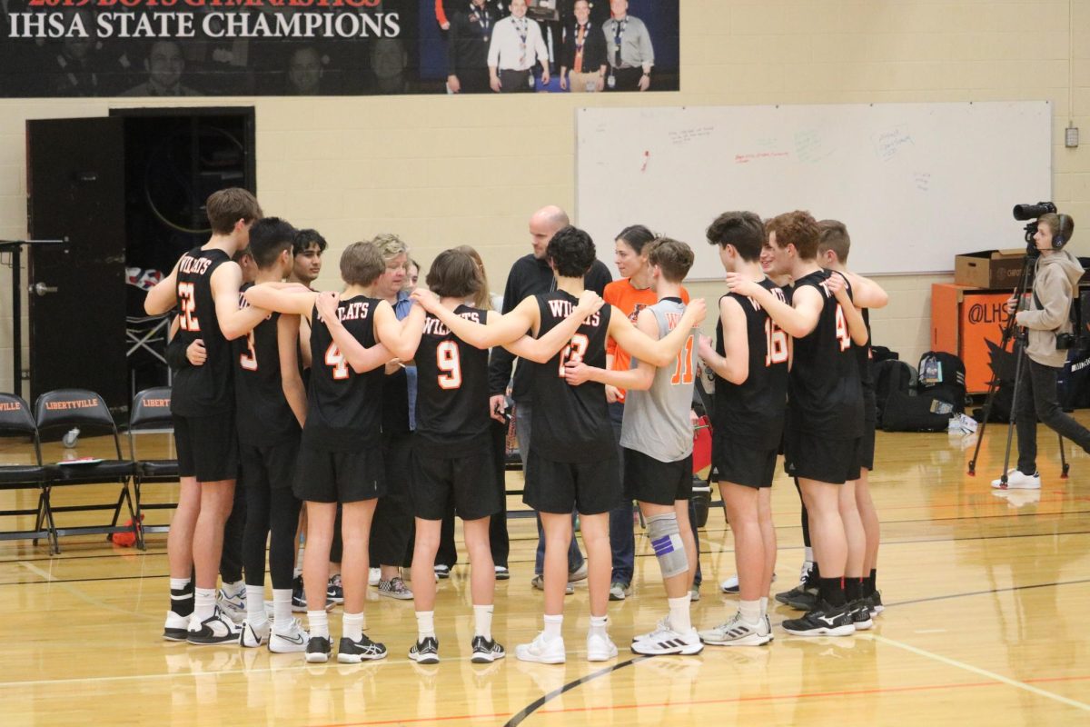 The Wildcats come together in-between sets. Despite losing the game, the team, according to junior Justin Howell (4), was said to have, “good positive energy, especially outside the court [and] good team chemistry.” 