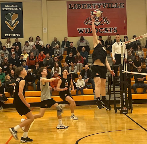 Junior middle hitter Jordan Coughlin (40) springs into the air to crush the ball over the net into Carmel territory. Coughlin was one of multiple players who earned kills, or unreturnable attacks, over the course of the night.