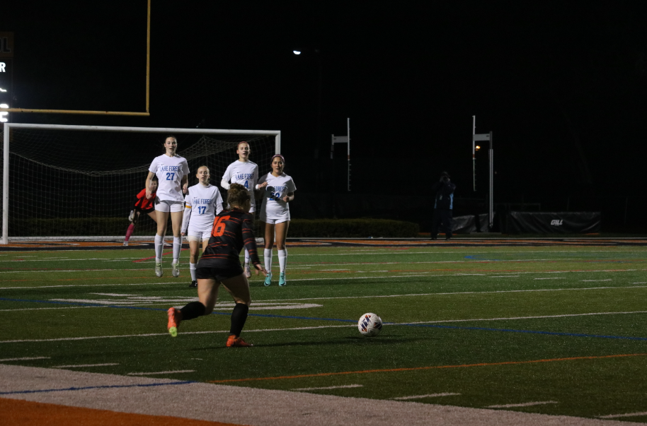 Sophomore Shea Krakowski (16) winds up for a penalty kick, in an attempt to secure another goal for the Wildcats.
