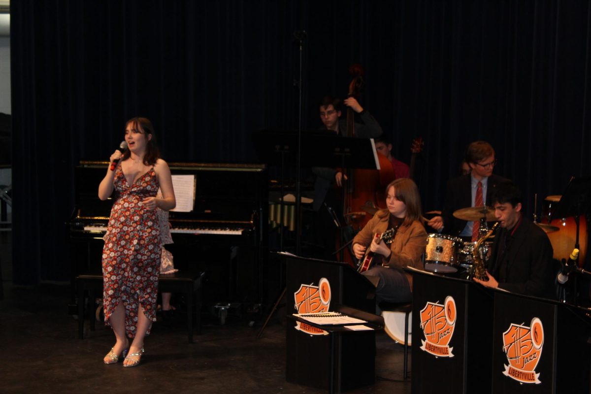 Junior Vocalist Wren Frey sings “Something’s Gotta Give” by Johnny Mercer with the Jazz Ensemble. 