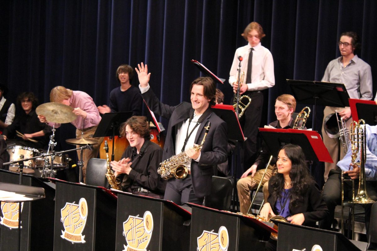 Senior Sam Foster, who plays the alto saxophone on the Jazz Lab Band, waves at the audience after their final piece. “[Jazz is] just something that I enjoy personally, and I wanted to do,” Foster said.