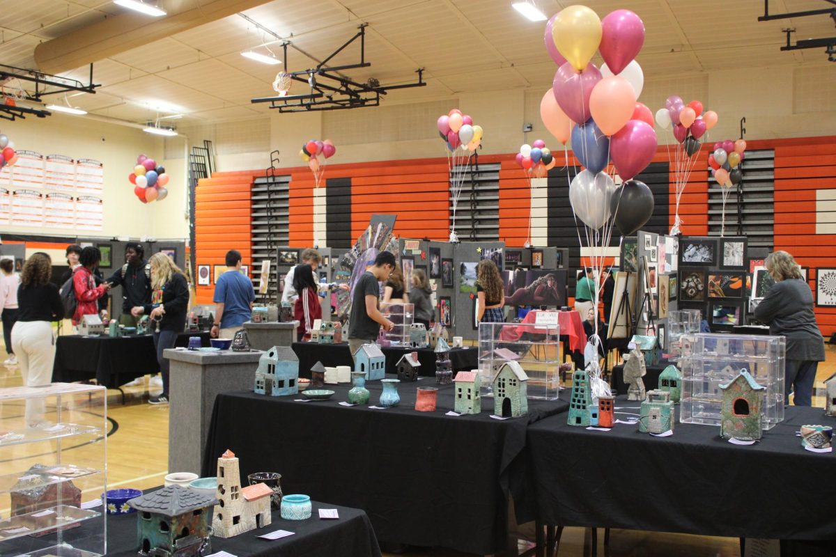 Welcome to the 2024 Art Show at Libertyville High School! The show, which occurs each year at the end of second semester, showcases artwork from students in art elective classes, including AP Portfolio, whose students displayed their work in their own separate booths. Different mediums such as pottery, glass blowing, metalsmithing, acrylic, and much more are displayed throughout the Main Gym, where the show is held.