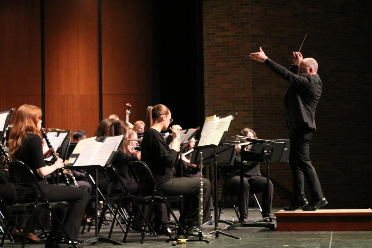 Mr. Adam Gohr, director of bands, conducts the piece “Ghosts of the Old Year" by James David. The song used its harmonies and musical phrases to tell the story of David’s unease about the state of the world. 