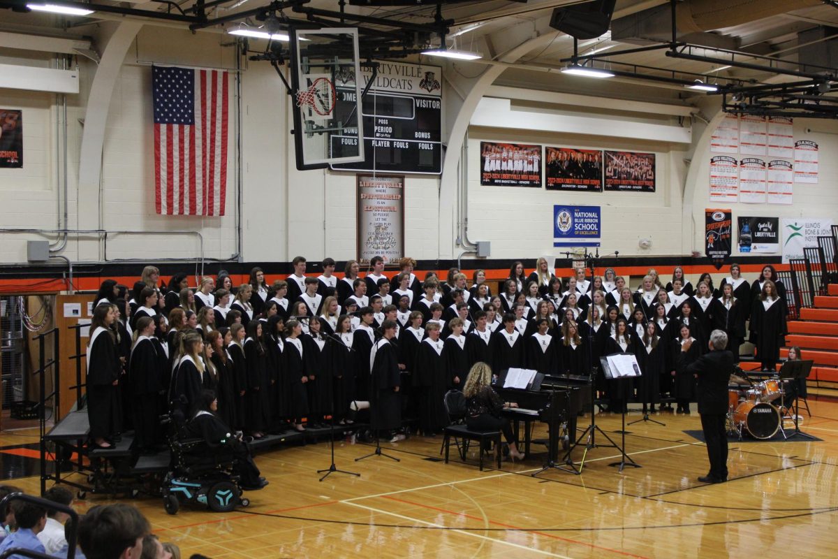 The combined LHS Choirs sing in the Main Gym on the night of October 30th. Pianist Mrs. Claire Dixon and senior Nina Landvick, playing the drums, accompany the chorale group in performing the song “I Put a Spell on You” from the 1993 movie, Hocus Pocus.