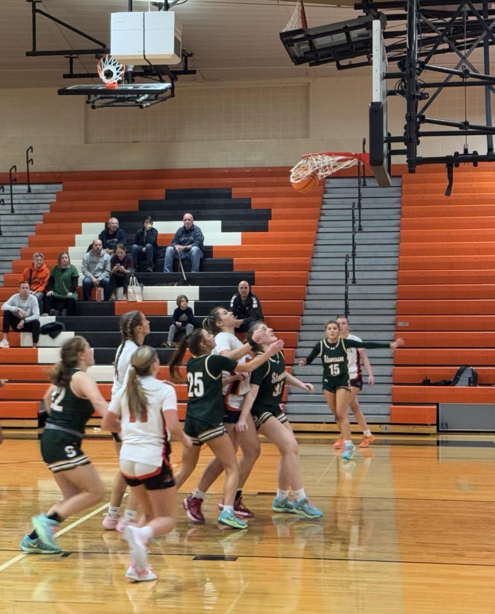 Senior Elinor Lindal (5) makes a shot off the baseline, as Wildcat teammates and Stevenson Patriots await a potential rebound.
