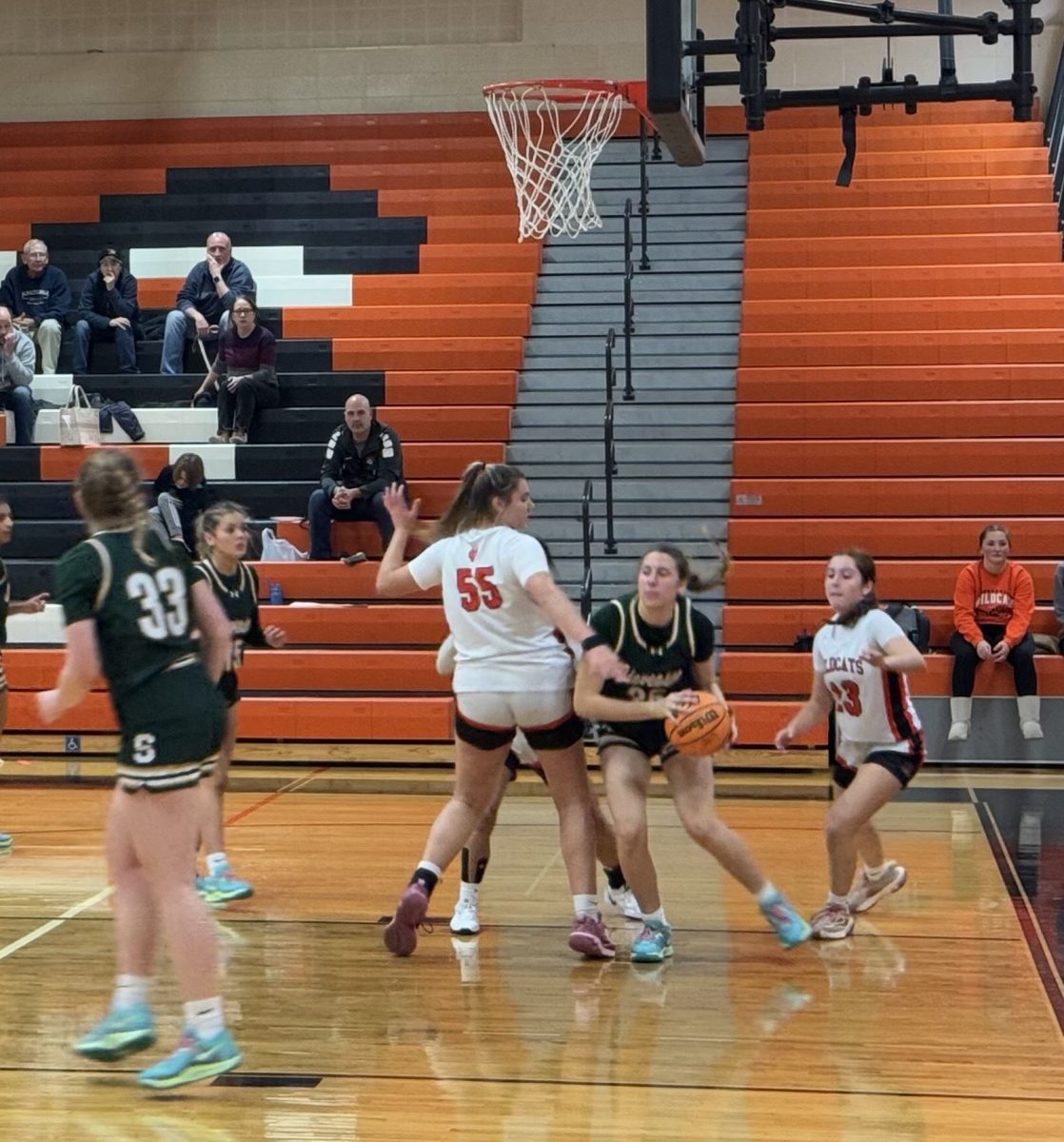 Senior Madison Sears (55) and Junior Ella Pawelczyk (13) attempt to cut off Stevenson and take the ball to fight for a win.
