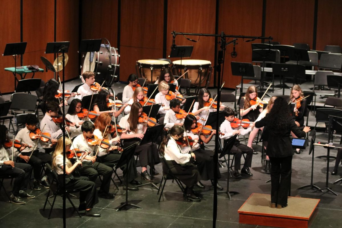 Guest Conductor Ms. Frakes conducts the Highland Middle School Orchestra. During the orchestra festival, the Highland Middle School performed the piece “Mabel Creek Overture”, as well as other pieces with the LHS Symphony Orchestra.