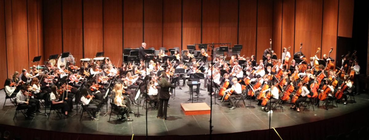 Guest Conductor Natalie Frakes steps to the podium to conduct the combined orchestras of the Highland Middle School and the LHS Symphony Orchestras. Ms. Frakes was invited to conduct during the 2024 Orchestra Festival on Thursday, December 5, 2024.