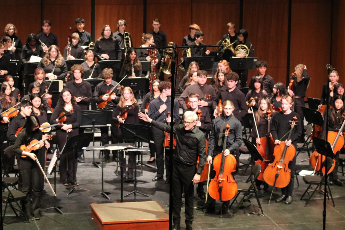 Conductor Jeremy Marino and the Symphony Orchestra receive a round of applause. The Symphony Orchestra played a total of three pieces last Thursday in the Orchestra Festival.