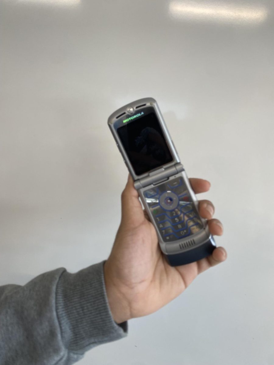 An old flip phone, specifically a Motorola V3. Even though it is named the V3, this was the first flip phone Motorola released all the way back in 2004. 