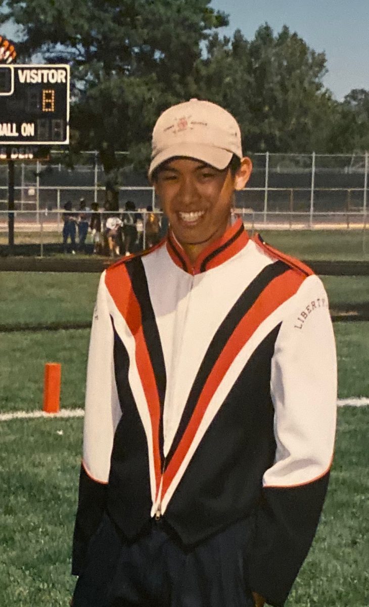 Mr. Chung poses for a photo in the marching band during a football game. He played the trumpet and was also in the Wind Ensemble. “I remember all the different concerts and competitions that we were involved in [and] we won super state for wind ensemble one of the years that I was there, which is a lot of fun and definitely a memory,” he said. (Photo courtesy of Mr. Chung)