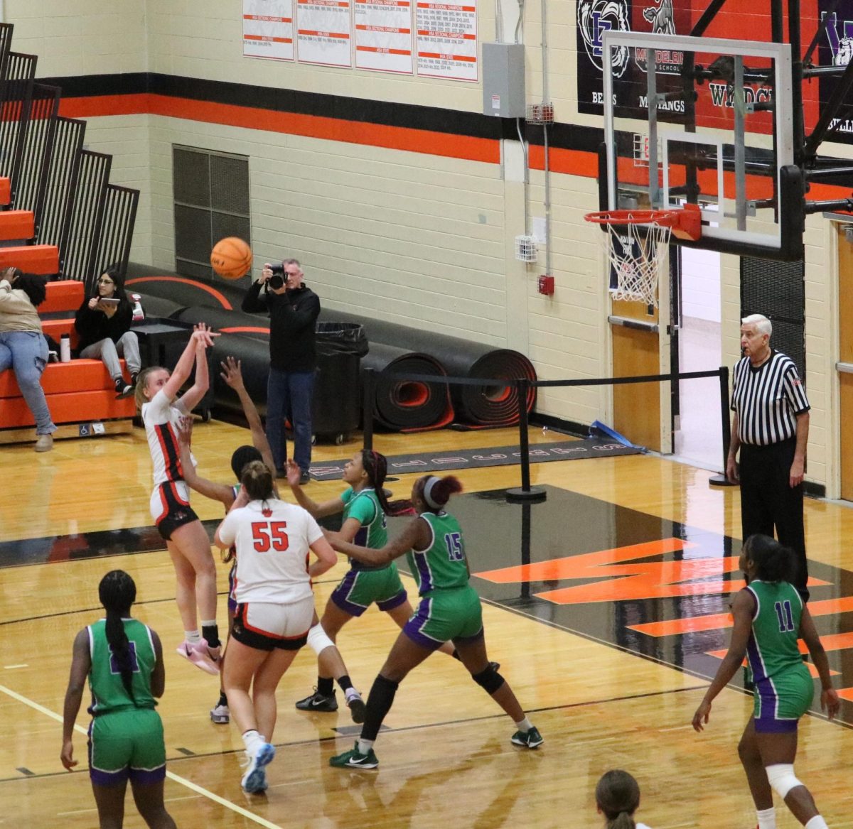 Senior Elinor Lindal (5) shoots against Waukegen’s defense. After the game, Coach Pedersen commented on Elinor’s performance, saying, “with Elinor, the motor is always going.”