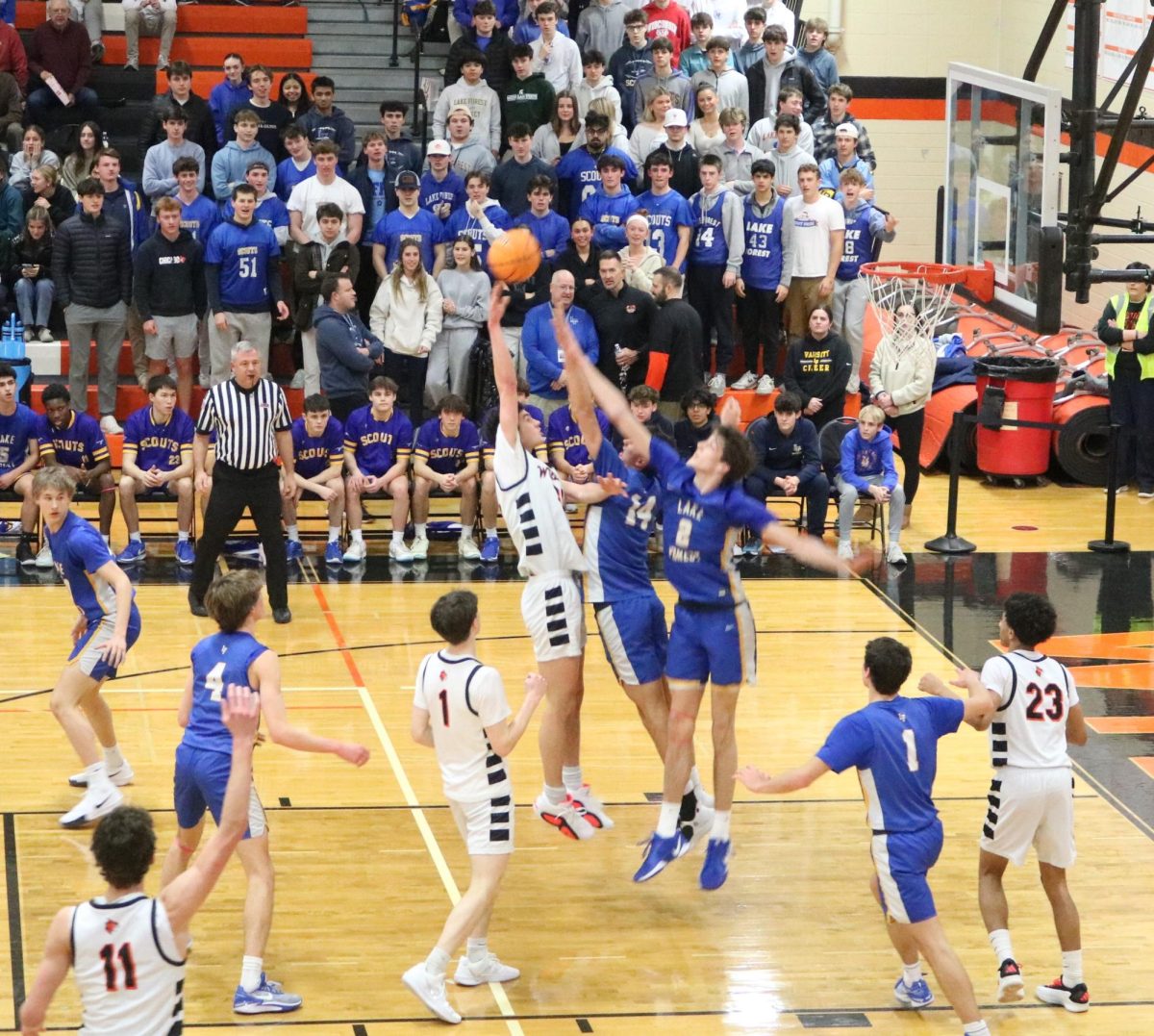 Junior Bryce Wegrzyn (32) takes a shot while being pressed by Lake Forest’s Hudson Scroggins (14) and Grant Mordini (2).