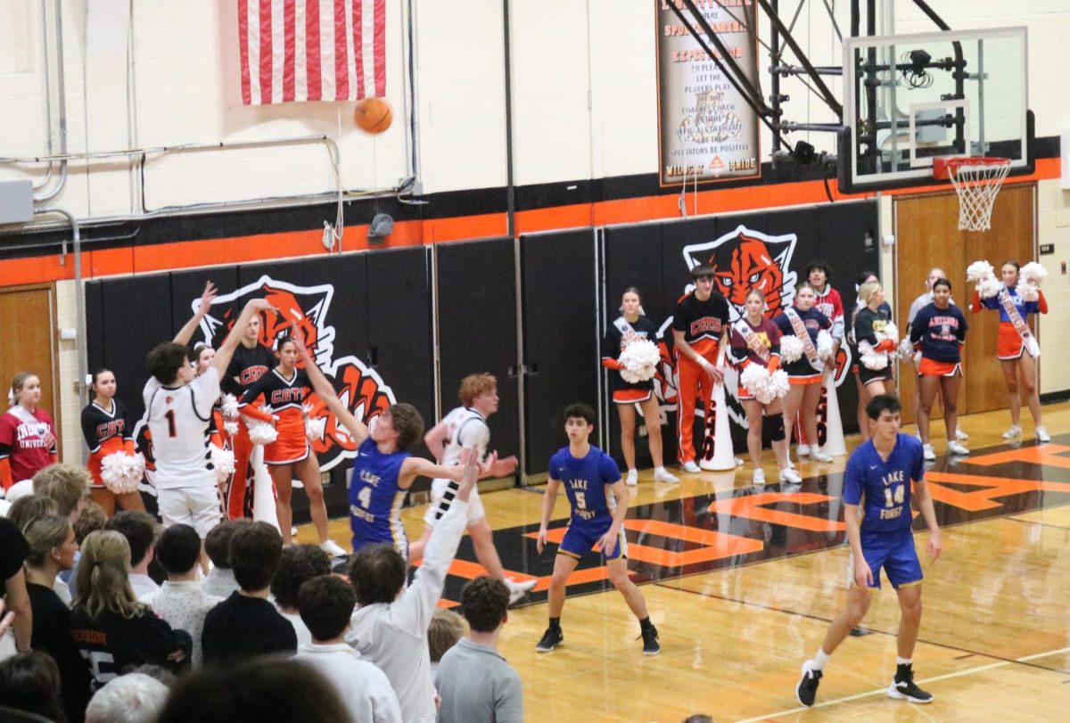 Senior Liam Hanson (1) attempts a three-pointer in the last second of the game against the Scouts. The Wildcats lost the close game against Lake Forest on Tuesday, February 11, 2025.