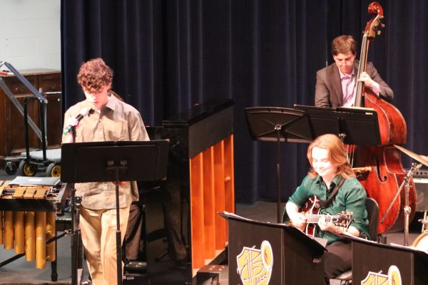 Senior River Thompson joins the Jazz Ensemble by singing “That Old Black Magic” by Mercer and Arlen Arr. Mark Taylor, along with senior Annie Brody on guitar and junior Thomas Teixeira on bass, earning big applause. “[The concert had] great energy because it's the last [jazz concert] of the year,” Brody said. 
