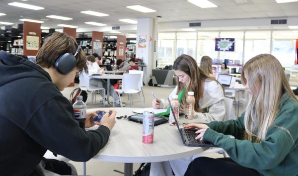 Juniors Gabby Verbeten, Ava Martin and Niko Messina complete their
schoolwork during their study hall while listening to music.