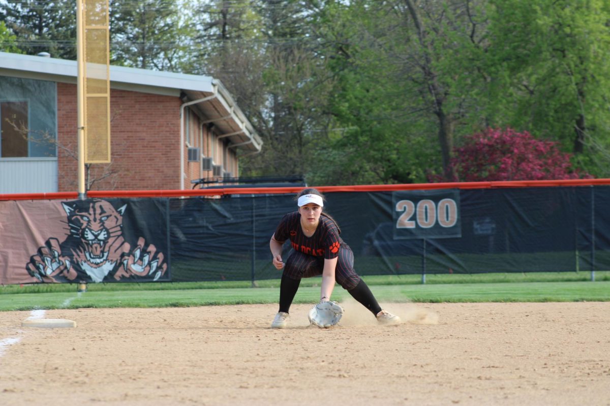 Senior Emily Psyhogios (11) stands in preparation for the batter. Psyhogios is continuing her softball career at Lake Forest College this coming fall. “The adversity I've faced and the friends I've made along the way have helped me grow as a person," Physhogios said. “I wouldn't be who I am without it.”
