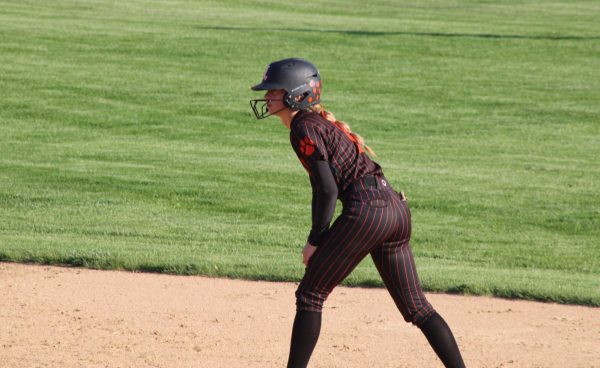 Junior Taylor Higham (1) waits on second base as her teammate takes on Mundelein's pitcher in a pivotal at bat. Higham is one of the teams' pitchers.