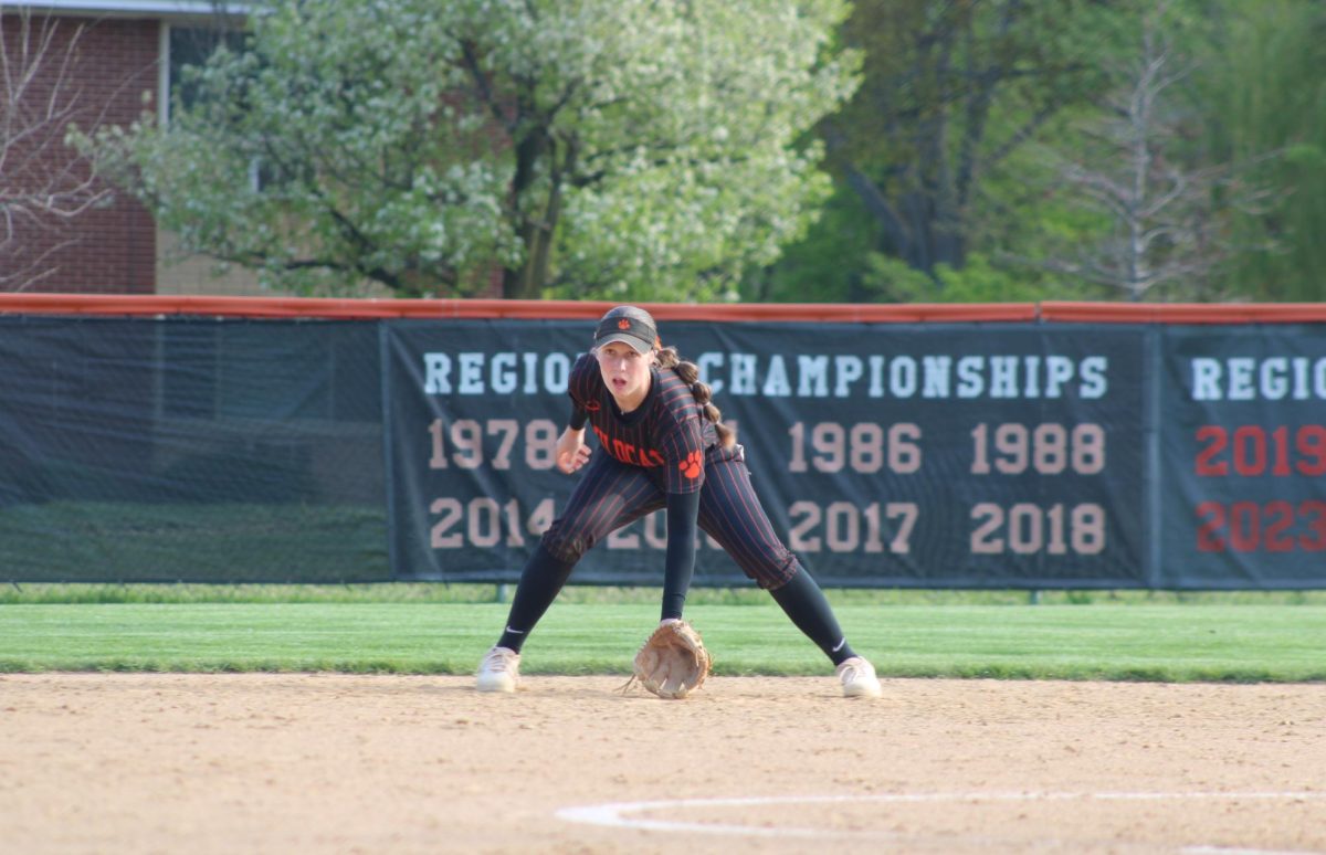 Senior Zoe Kinsella (14) dives down as the Mustangs get a hit. By the fourth inning the score was 3-2, putting the Wildcats in the lead.