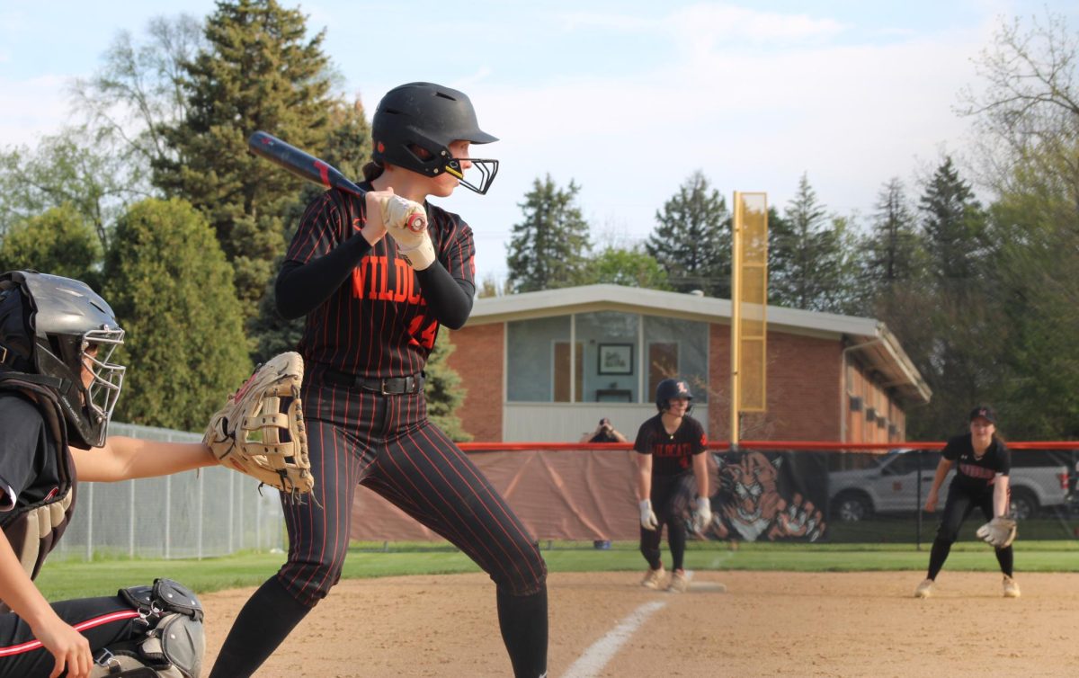 Senior Zoe Kinsella (14) steps up to the plate as freshman Juliana Figurelli (4) waits at third base for a chance to steal home. "Just play every game at a time, not think too far ahead and focus on where we are at that moment," senior Kinsella said.