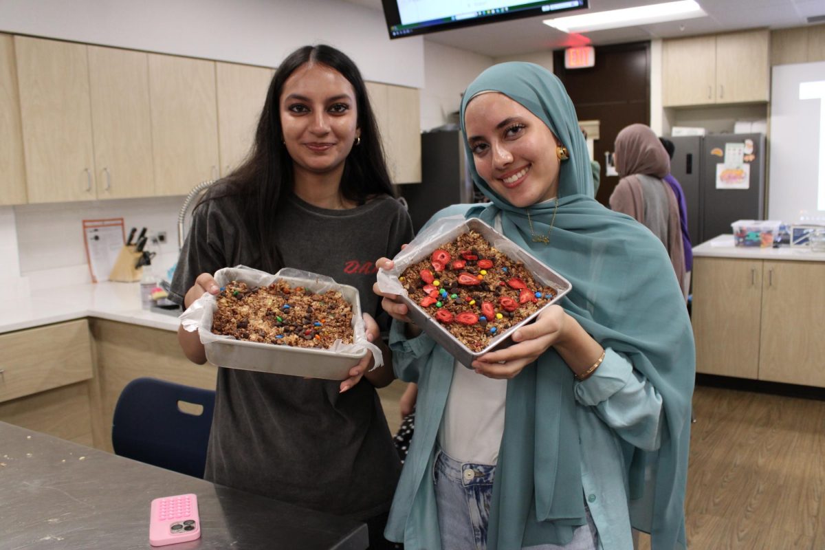 Juniors Jenin Moghieb and Minha Waheed pose with their freshly made halal rice krispy treats. Since marshmallows contain gelatin, which Muslims can’t eat, the club used gelatin-free marshmallows to make this sweet treat. 