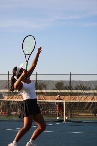 Senior Maddy Chung serves the winning point of the match. Playing tennis at the high school level for the all four years, she has grown as a player throughout.